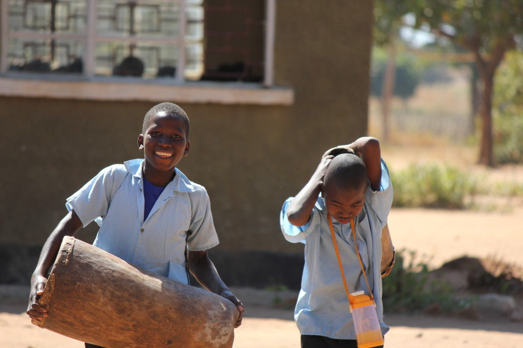 Dwankhozi students carry a drum during free time.