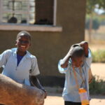 Dwankhozi Students Carry A Drum During Free Time.